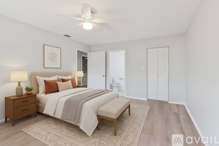 A bedroom with a bed, nightstand, and a rug.