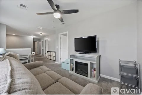 A living room with a television and a couch.