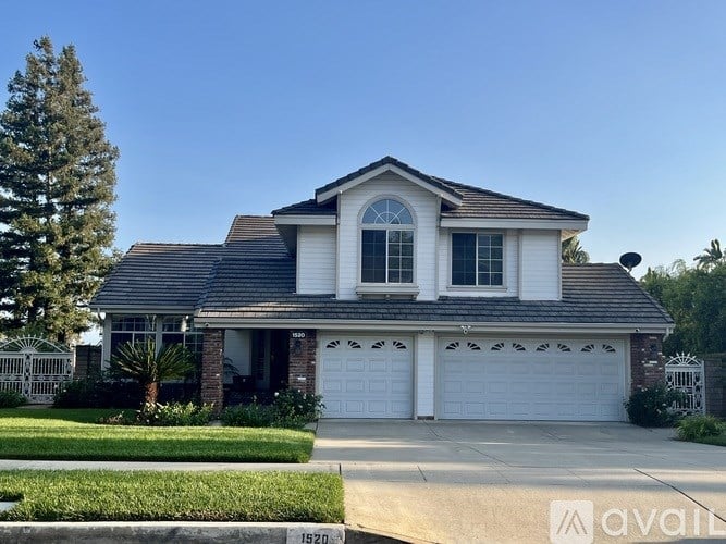 A two-story house with a garage is for sale.