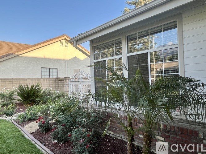 A house with a garden in front of it.