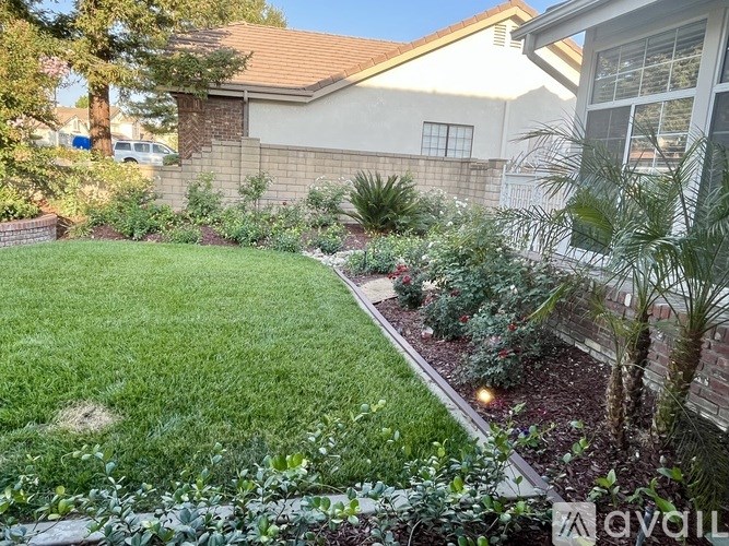 A well-maintained garden in front of a house.
