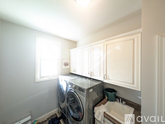 A small laundry room with a washer and dryer.