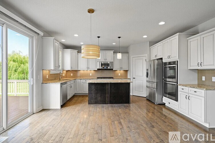 A modern kitchen with white cabinets and a center island.