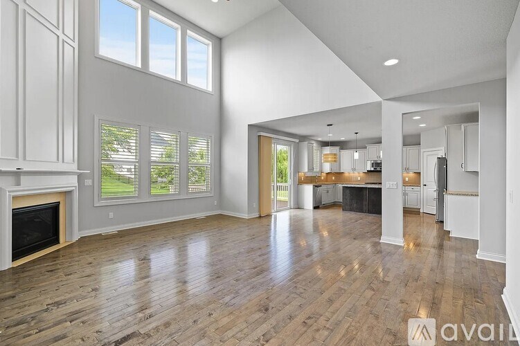 A spacious living room with hardwood floors and a fireplace.