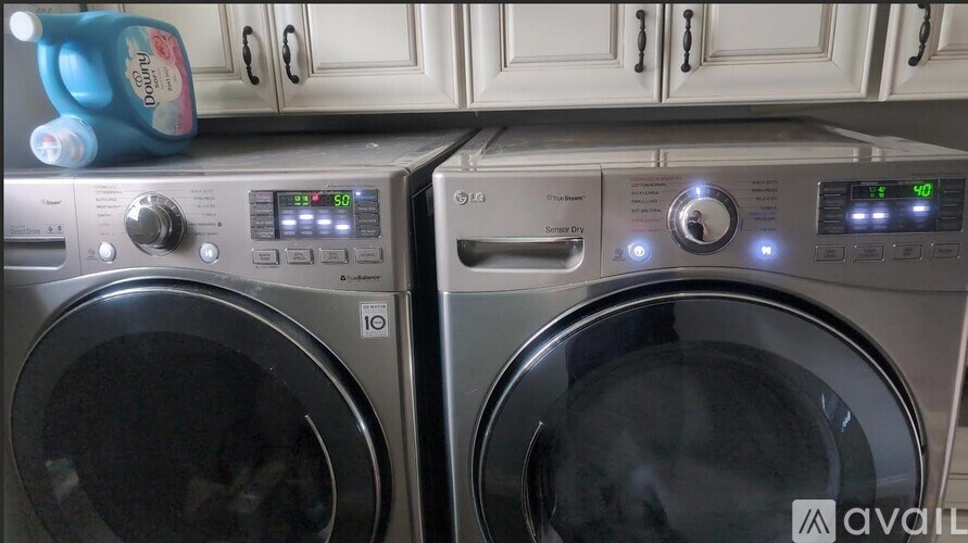 Two front loading washing machines are on a counter.