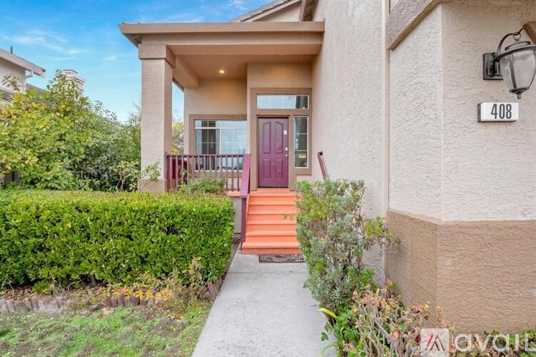 A house numbered 408 with a red door and steps leading to the entrance.