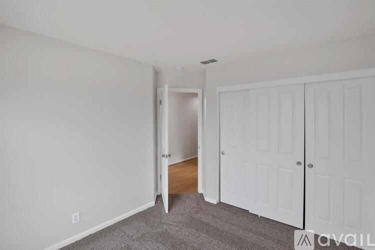 A room with a white door and a white cabinet.