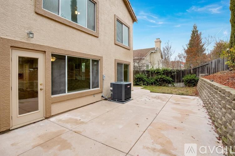 A house with a patio and a wall on the side.