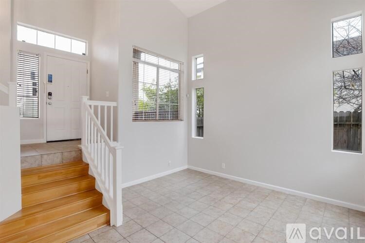 A room with a staircase leading to the upper floor.