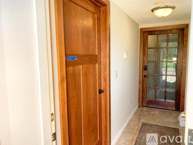 A wooden door with a glass window on the other side.