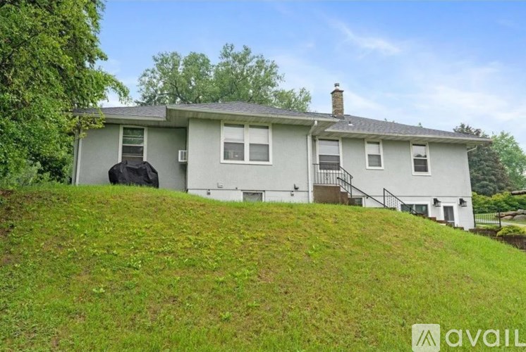 A house with a green lawn in front of it.
