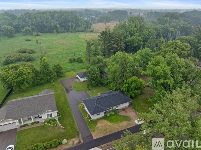 A bird's eye view of a property with two houses and a driveway.
