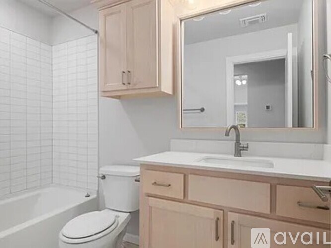 A bathroom with a white toilet, a sink, and a bathtub.