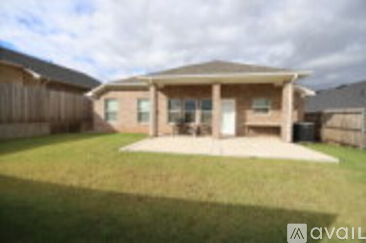 A house with a brown roof and a covered patio.