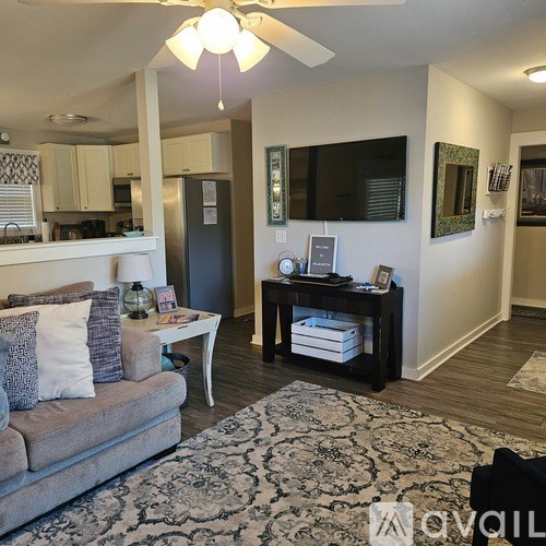 A living room with a grey couch and a coffee table.