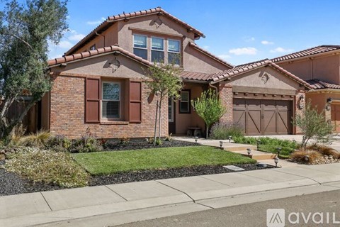 A house with a brown brick exterior and a tiled roof.