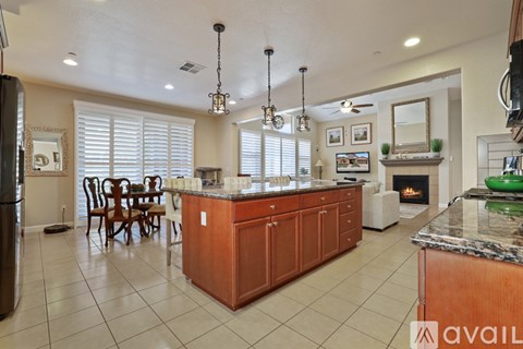 A kitchen with a large island and a refrigerator.