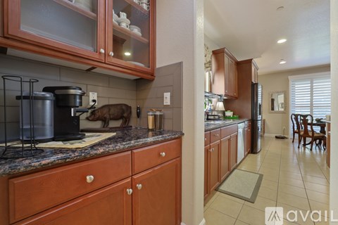 A kitchen with wooden cabinets and a granite countertop.