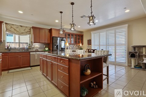 A kitchen with wooden cabinets and a central island.