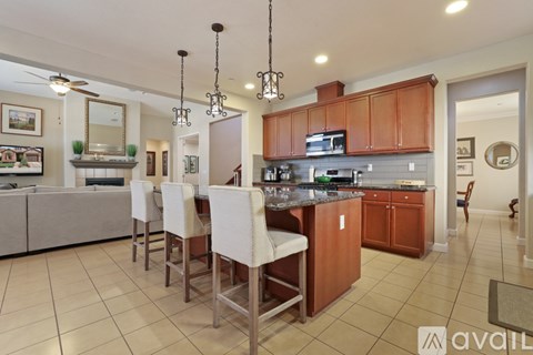 A kitchen with brown cabinets and a white island.