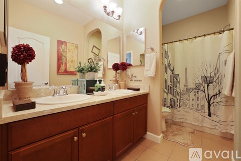 A bathroom with two sinks and a large mirror.