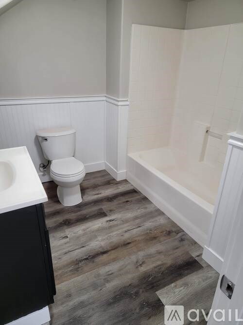 A bathroom with a toilet, sink, and bathtub.