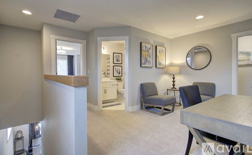 A living room with a grey couch and a wooden table.