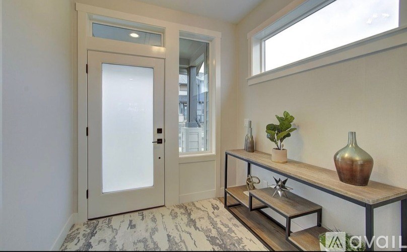 A room with a marble floor and a wooden bench with a vase on it.