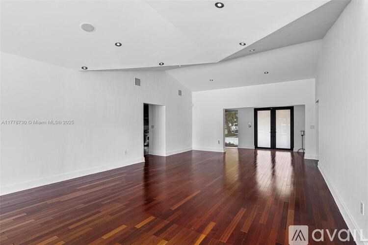A room with wooden floors and white walls.