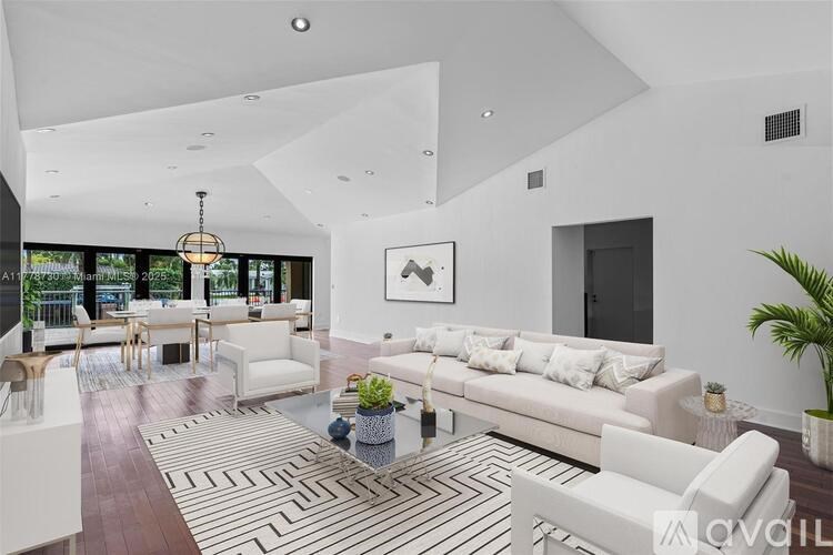 A living room with a white couch and a coffee table.