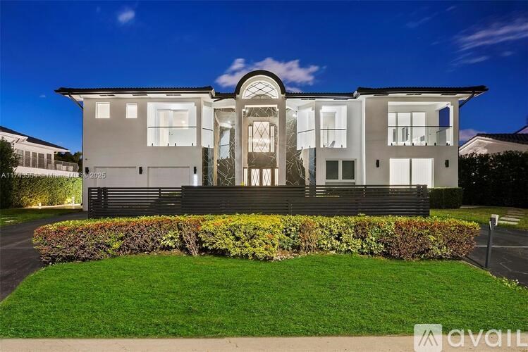 A modern house with a well-maintained lawn in front.