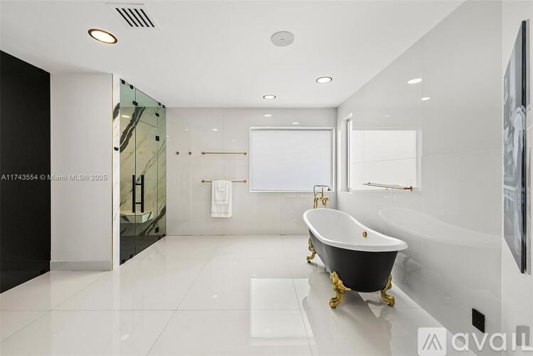 A modern bathroom with a black and white color scheme.