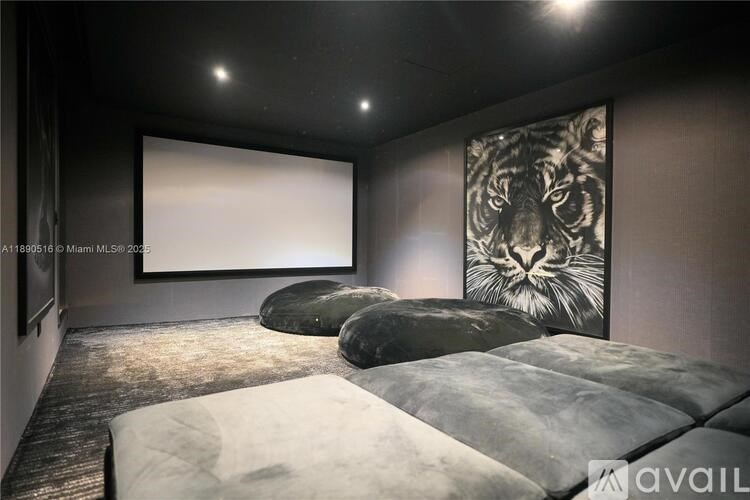A home theater with a large screen and comfortable seating.
