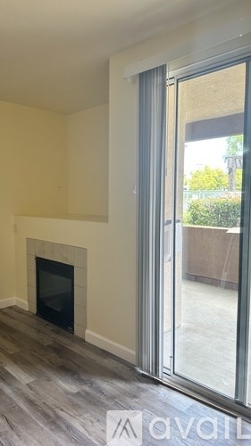 A living room with a fireplace and sliding glass doors.
