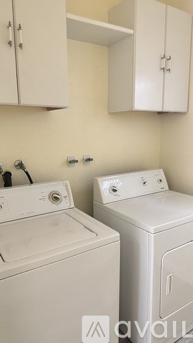 A washing machine and dryer in a laundry room.