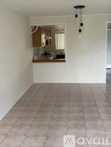 A room with a tiled floor and a mirror on the wall.