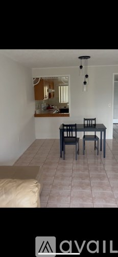 A dining room with a table and chairs.