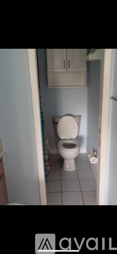 A white toilet in a small bathroom.