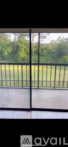 A black metal fence with a view of a green field.