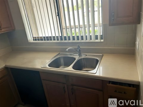 A kitchen with a sink and a window.