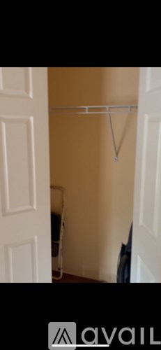 A white door with a white frame and a white wall.
