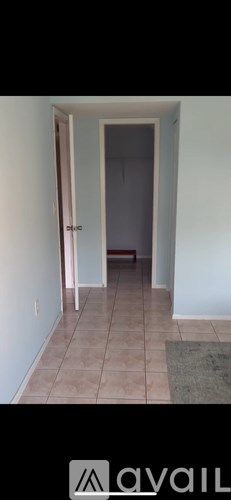 A room with a doorway leading to another room.