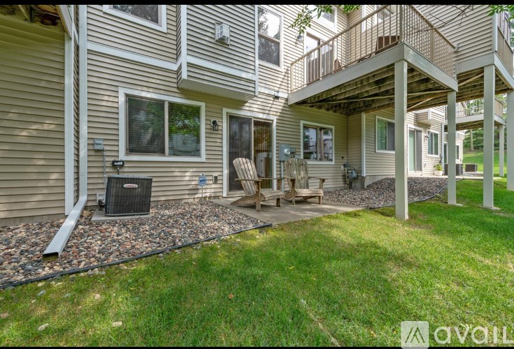 A house with a patio and a grill.