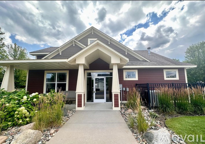 A house with a red and brown exterior and a white roof.