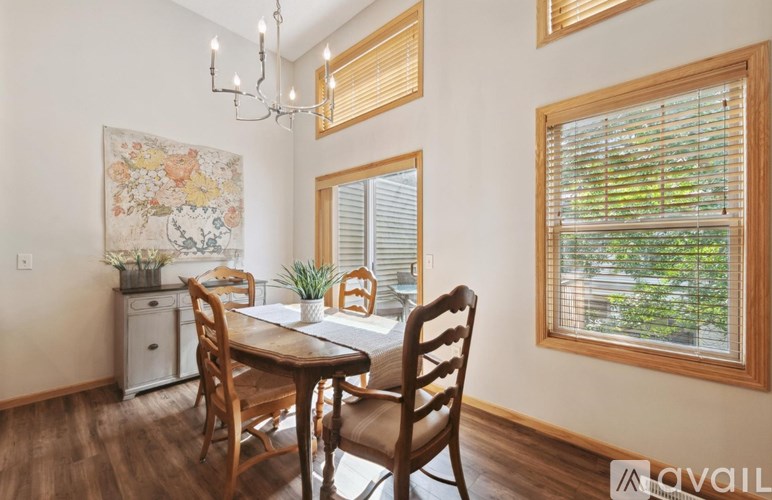 A dining room with a wooden table and chairs.