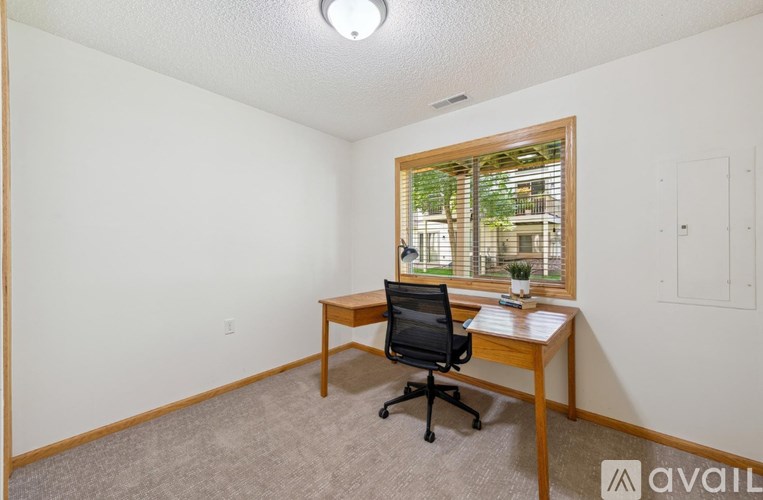 A room with a desk and a chair.