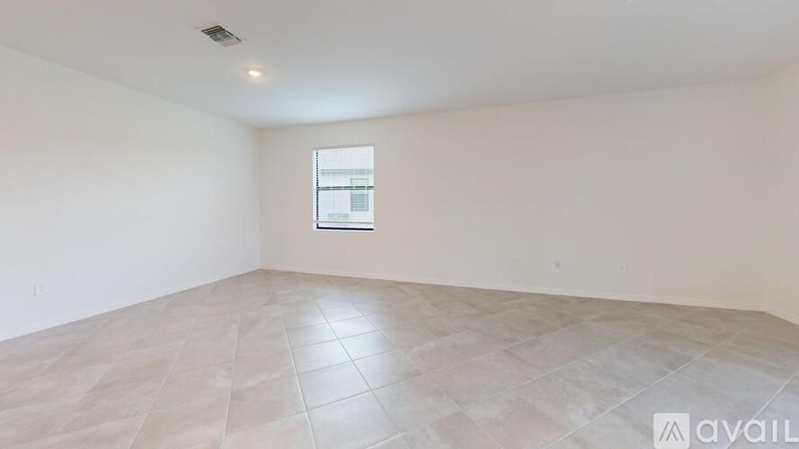 Empty room with tiled floor and a window.