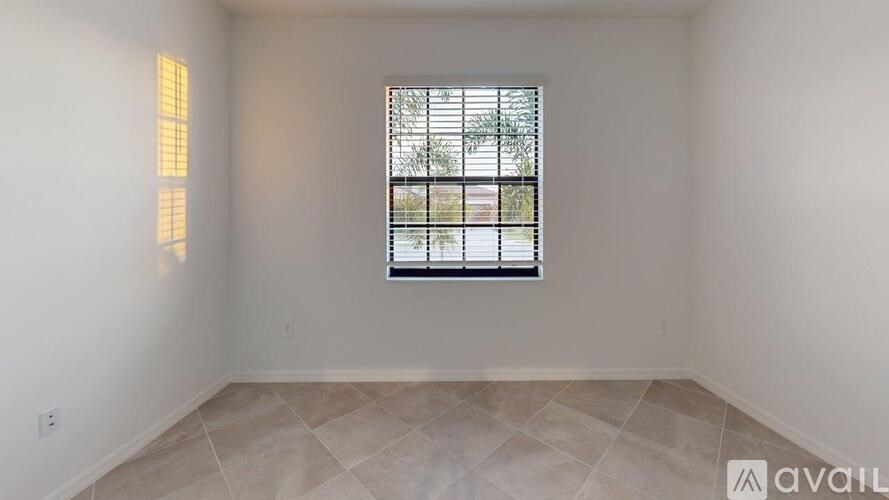 A room with a window and tiled floor is available for rent.