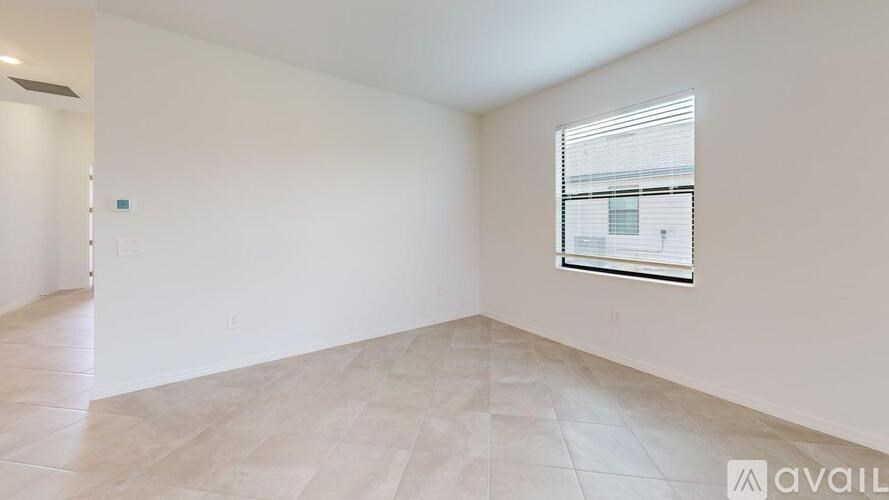 A room with a window and a tiled floor.