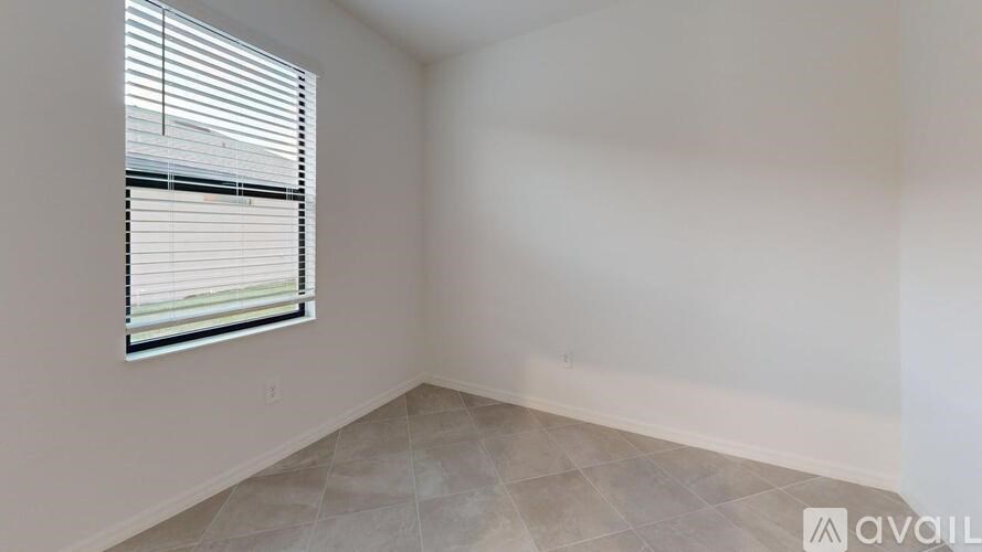 A room with a window and tiled floor is available for rent.